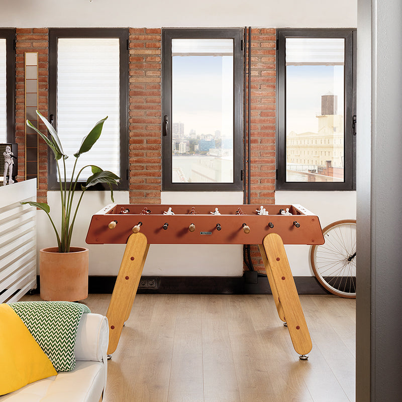 Wooden RS Barcelona table football in modern living room interiors.